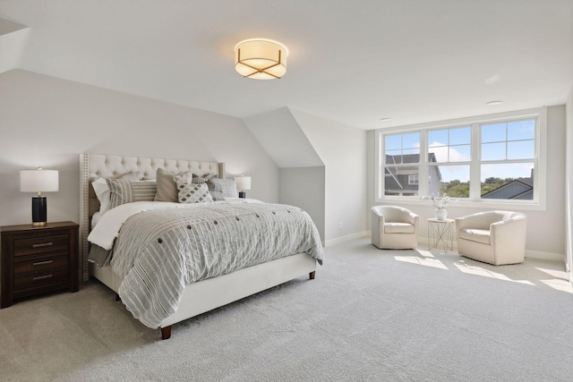 bedroom with light carpet, baseboards, and vaulted ceiling