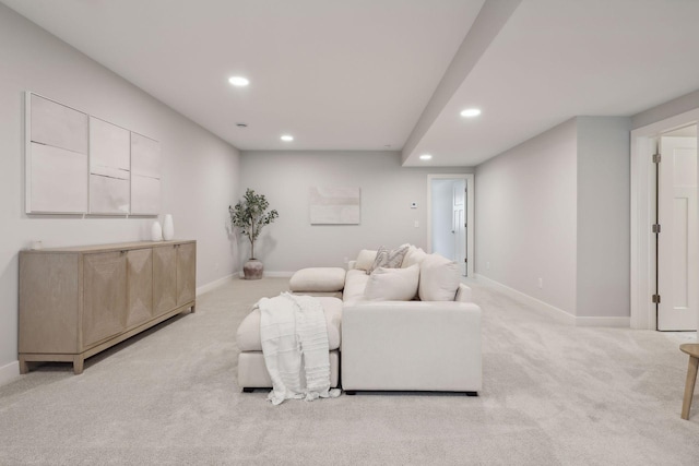 carpeted living area with recessed lighting and baseboards