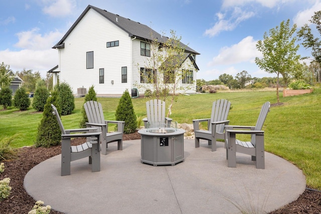 rear view of property featuring a patio area, central AC, an outdoor fire pit, and a yard