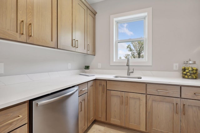 kitchen featuring a sink, dishwasher, light brown cabinetry, and light countertops