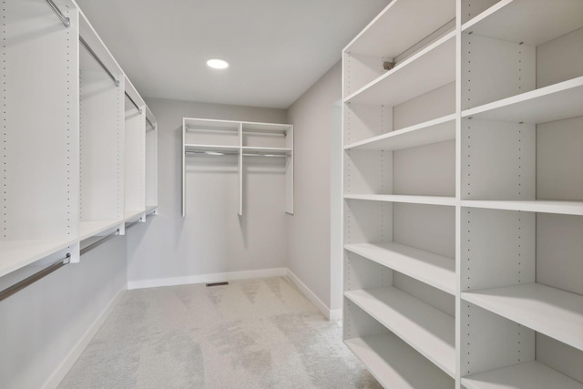 walk in closet featuring carpet floors