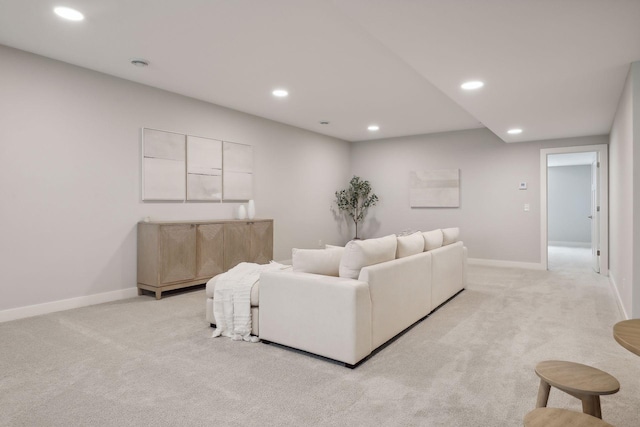 living area featuring light carpet, recessed lighting, and baseboards