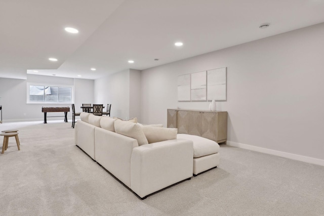 living room with recessed lighting, baseboards, and light carpet