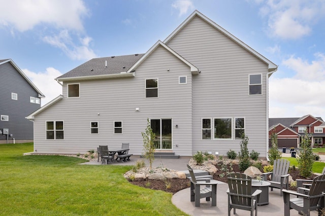 back of property featuring a yard, a patio area, and a fire pit