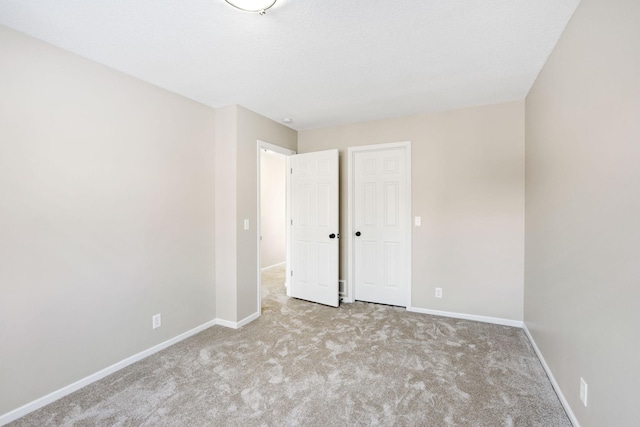 unfurnished bedroom with light carpet