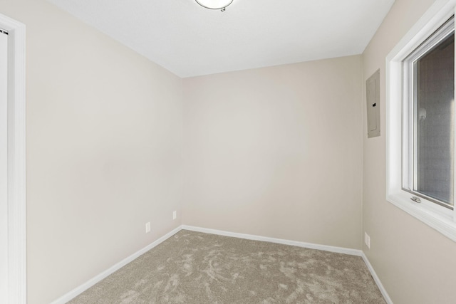 empty room with light carpet and electric panel