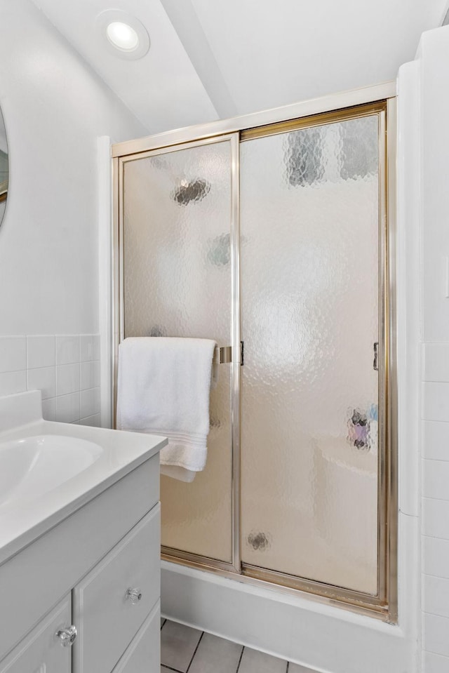 full bath featuring tile patterned flooring, vanity, and a shower stall