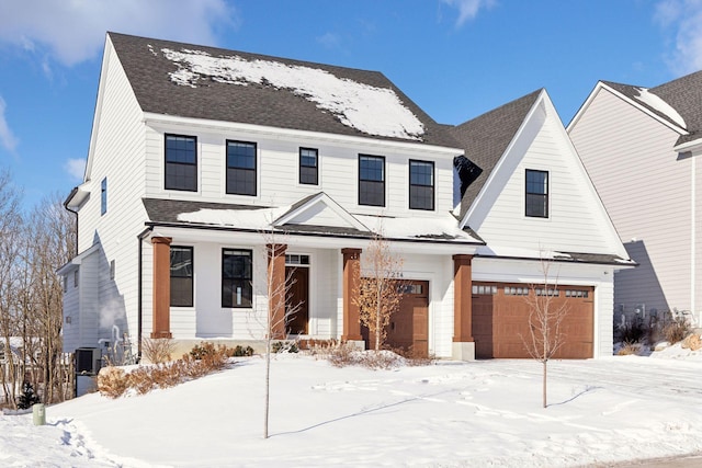 modern farmhouse style home featuring a garage and roof with shingles