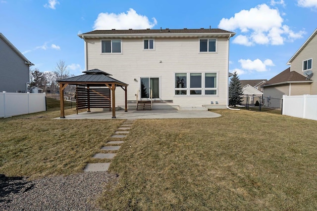 back of property with a gazebo, a yard, and a patio