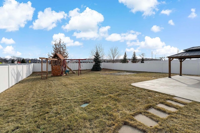 view of yard featuring a gazebo, a playground, and a patio area