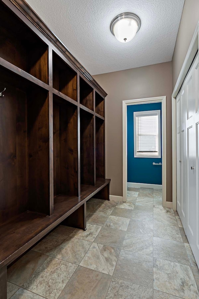 mudroom featuring a textured ceiling