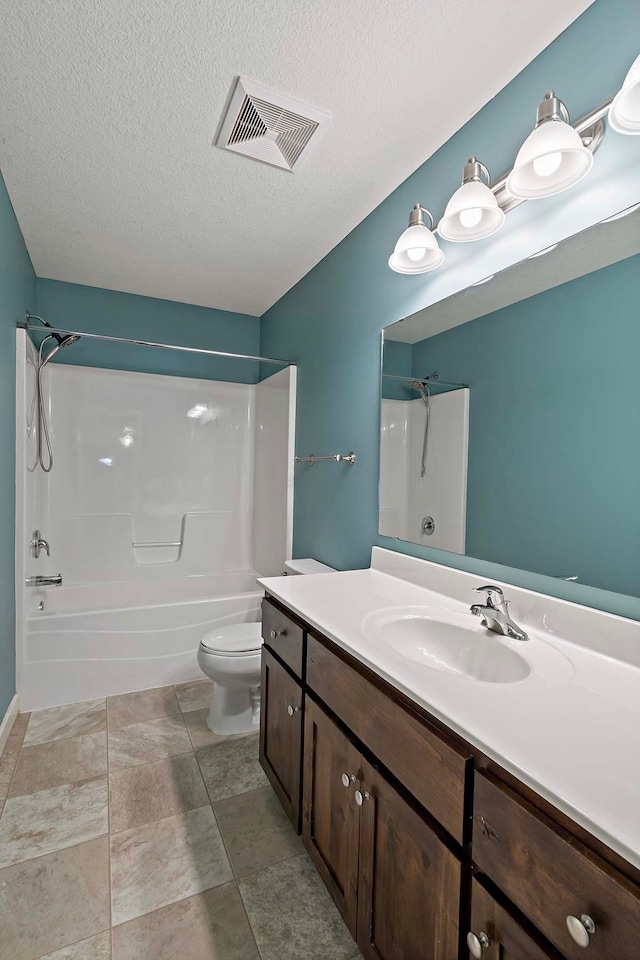 full bathroom with vanity, toilet, shower / washtub combination, and a textured ceiling