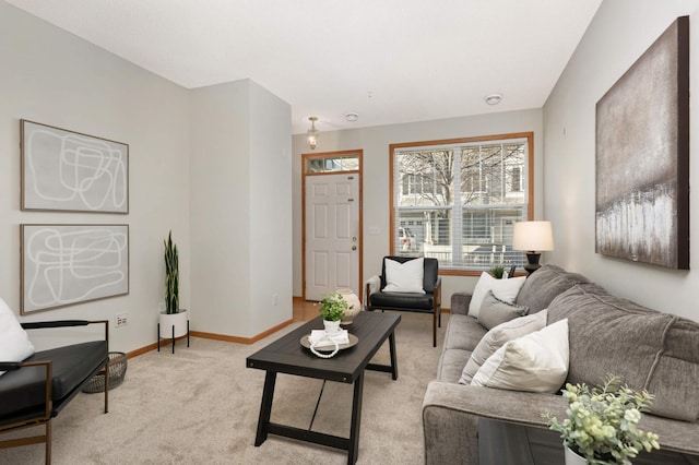 living area with light carpet and baseboards