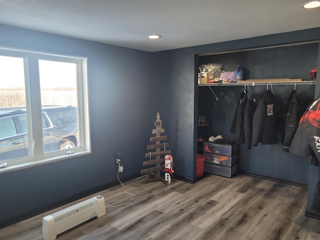 bedroom featuring a closet, wood finished floors, and recessed lighting