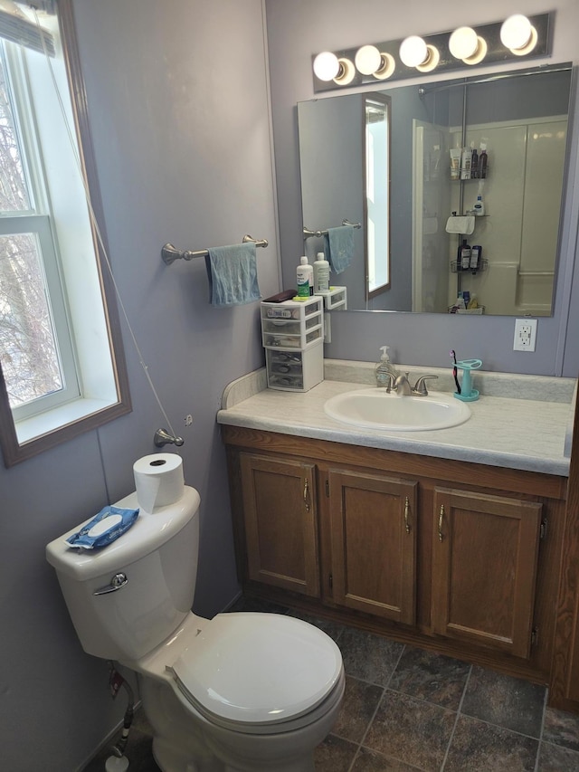 bathroom with toilet and vanity