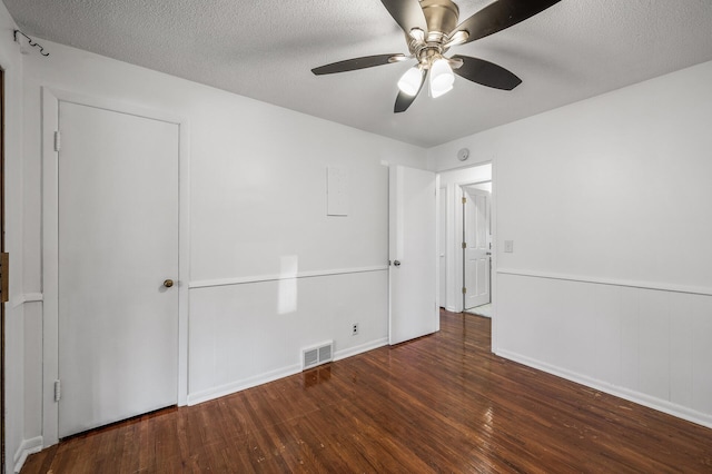 unfurnished bedroom with visible vents, a textured ceiling, ceiling fan, and hardwood / wood-style flooring