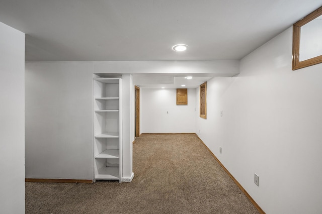 finished basement with baseboards and carpet flooring