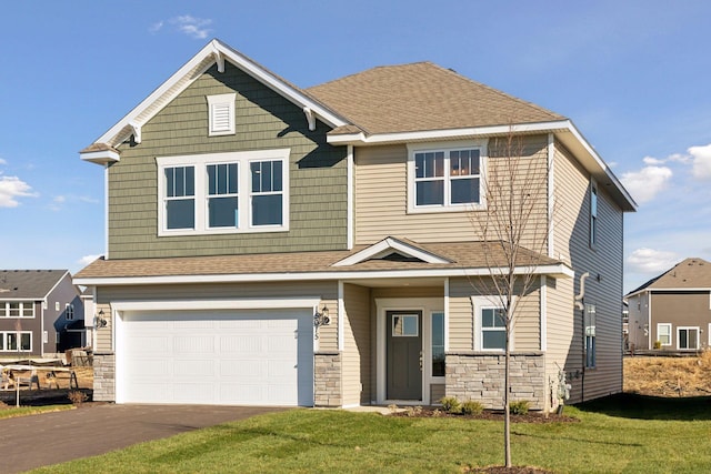 craftsman-style house featuring a garage and a front lawn