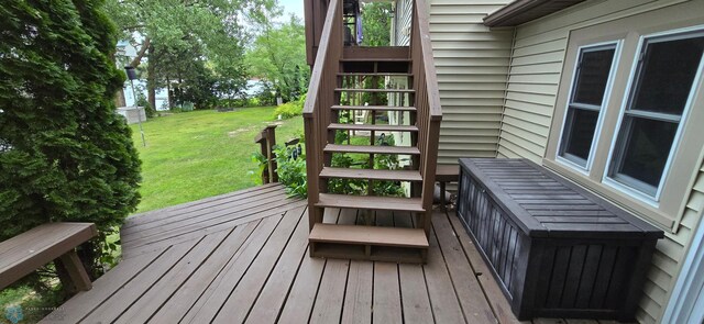 wooden deck with a yard and stairs