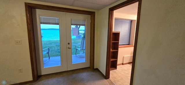 doorway to outside with light floors, baseboards, and french doors