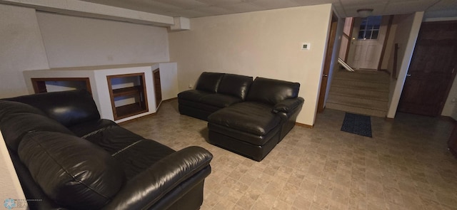 living room featuring stairway