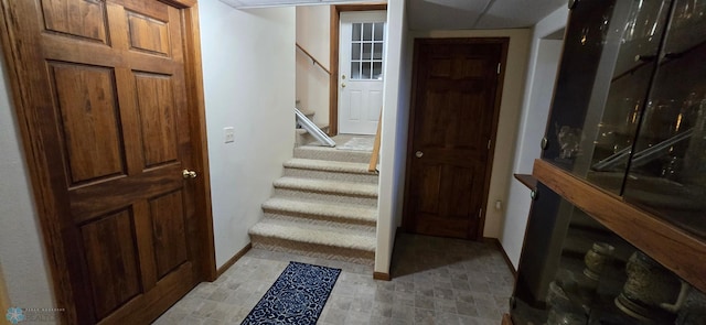 stairs featuring baseboards and tile patterned floors