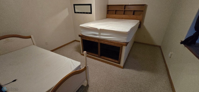 bedroom featuring carpet and baseboards