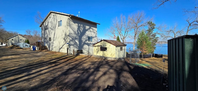 view of side of home with a shed and an outdoor structure