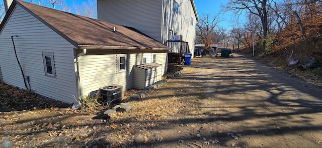 view of side of home with central AC