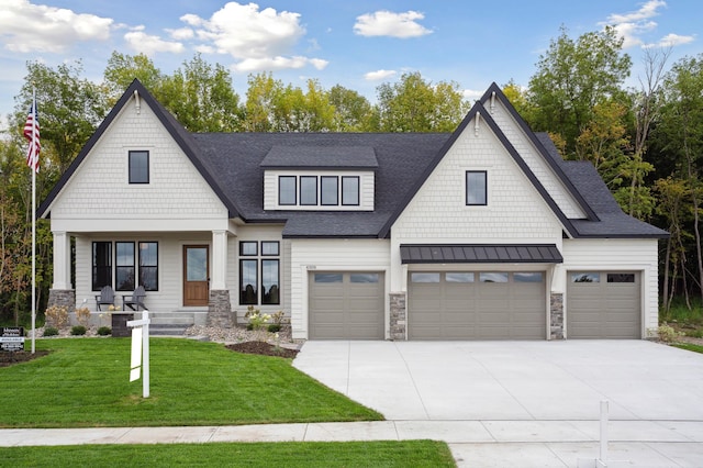 view of front facade with a garage, a front yard, and a porch