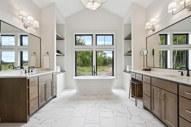 bathroom featuring vanity, a bathtub, and high vaulted ceiling