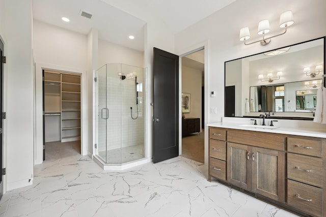 bathroom featuring vanity and a shower with shower door