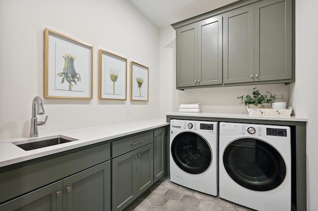 washroom featuring cabinets, sink, washer and dryer, and light tile patterned floors