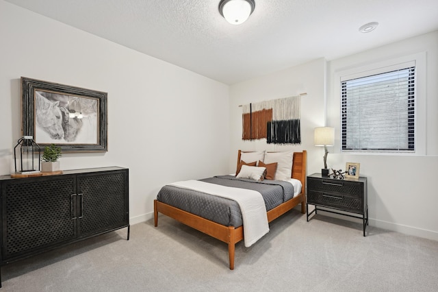 carpeted bedroom featuring a textured ceiling