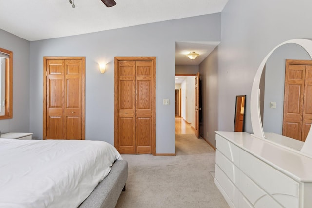 bedroom with lofted ceiling, light colored carpet, and ceiling fan