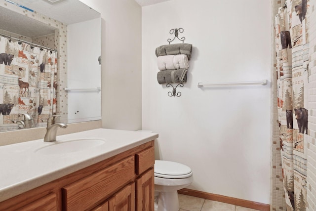 bathroom featuring tile patterned floors, toilet, vanity, and a textured ceiling