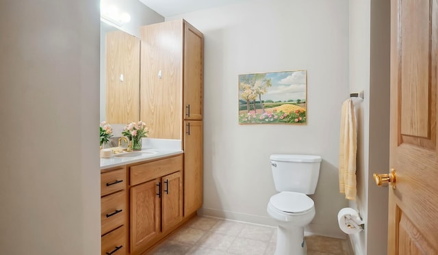 bathroom featuring vanity, toilet, and baseboards