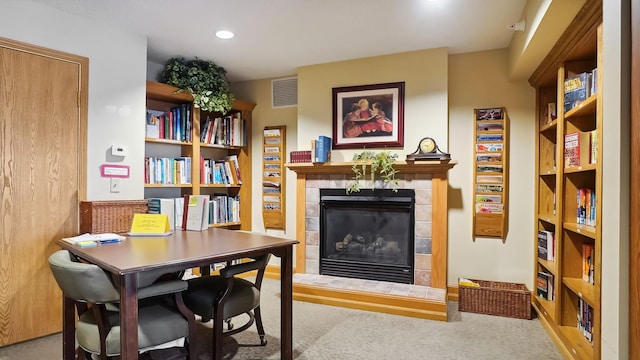 living area featuring carpet floors, recessed lighting, visible vents, and a fireplace