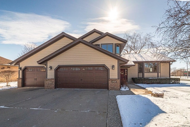 view of front of home with brick siding, driveway, and an attached garage