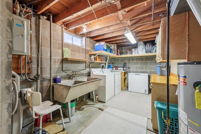 below grade area with a sink, fridge, water heater, and washer and dryer