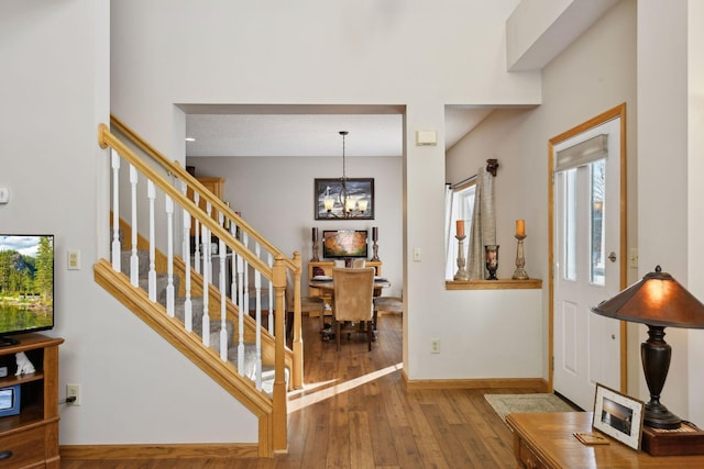 entryway featuring an inviting chandelier and hardwood / wood-style floors