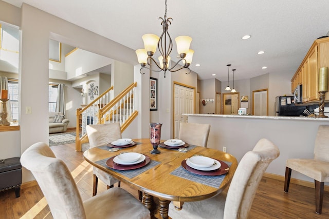 dining room featuring an inviting chandelier and light hardwood / wood-style flooring