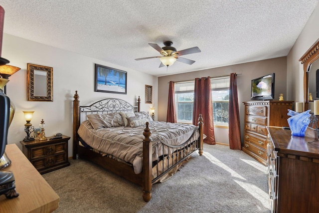 bedroom featuring ceiling fan, dark carpet, and a textured ceiling