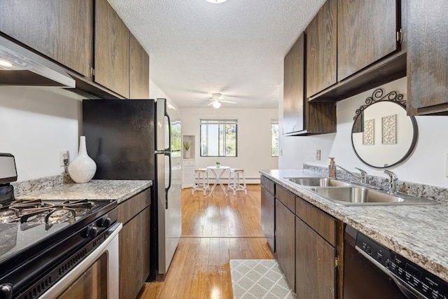 kitchen with dishwasher, a textured ceiling, light wood-type flooring, a sink, and gas stove