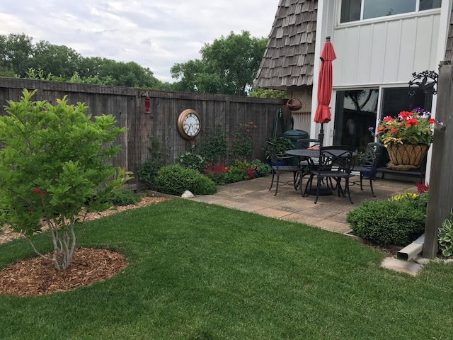 view of yard featuring fence private yard and a patio