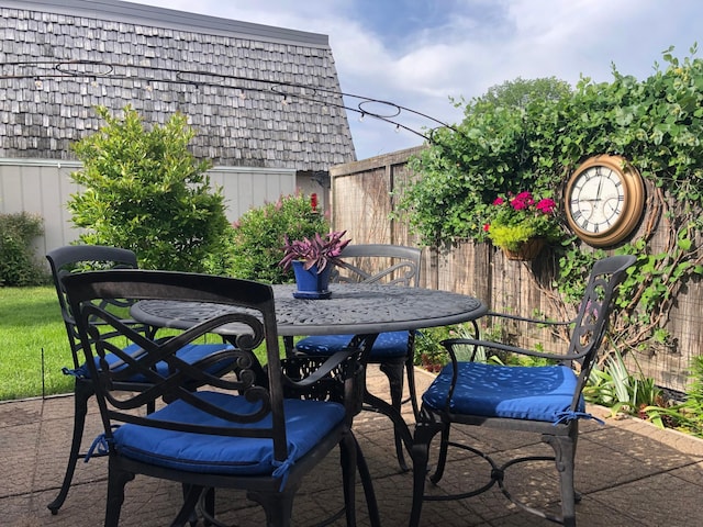 view of patio with outdoor dining area and fence