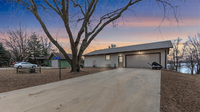 view of front of property featuring concrete driveway and an attached garage