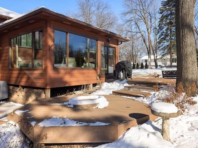 snow covered deck with grilling area