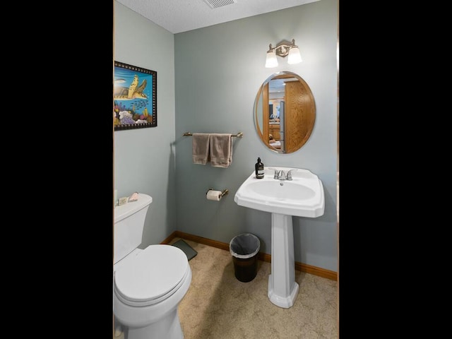 bathroom featuring toilet and sink