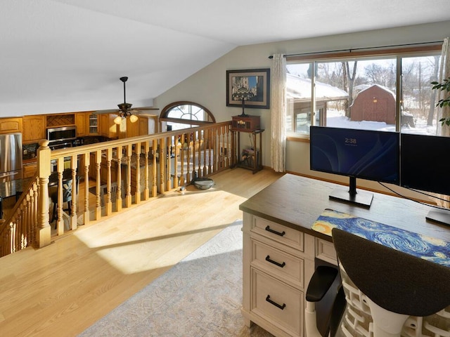 office with lofted ceiling, ceiling fan, and light hardwood / wood-style flooring